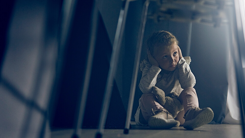 Ung stelpa heldur fyrir eyrun.